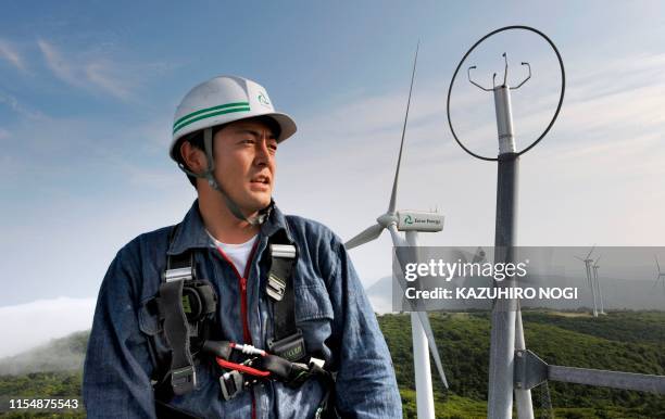 Japan-environment-climate-warming, by Patrice Novotny Ryo Nagasawa, a chief mechanic of wind-power farm Eurus Energy Japan Corp, works on top of a...