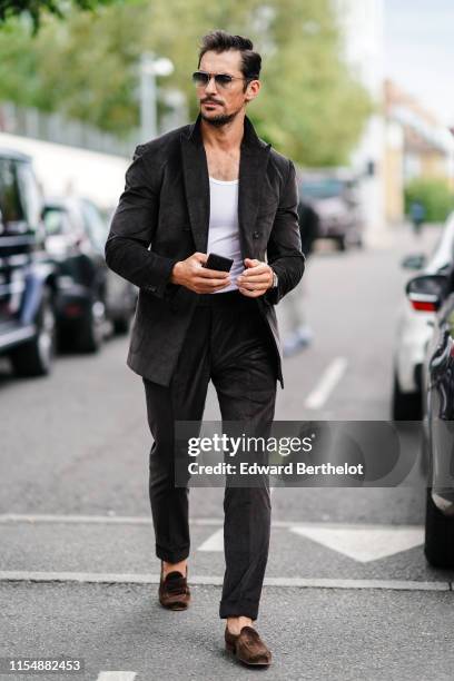 David Gandy wears a blazer jacket, a white t-shirt, sunglasses, during London Fashion Week Men's June 2019 on June 09, 2019 in London, England.