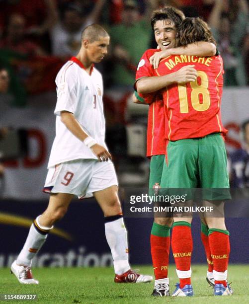 Portugal's midfielder Maniche and striker Deco celebrate next to Spain's striker Fernando Torres , 20 June 2004 at Jose Alvalade stadium in Lisbon,...