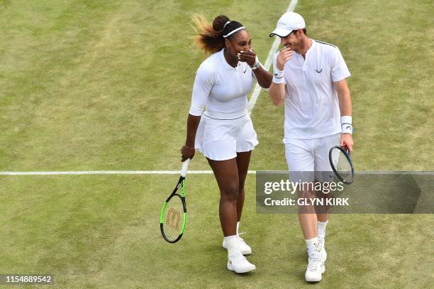 Britain's Andy Murray and US player Serena Williams talk as they play Brazil's Bruno Soares and US players Nicole Melichar during their mixed doubles...