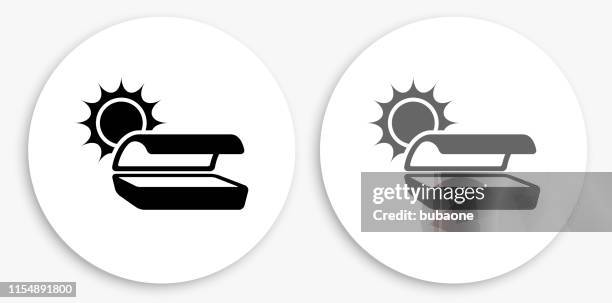 tanning bed black and white round icon - tanning bed stock illustrations