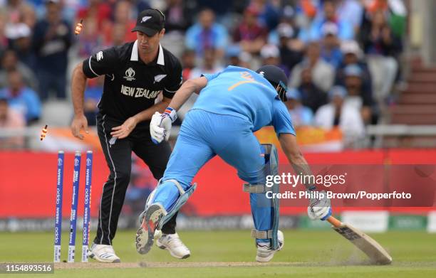 Colin de Grandhomme of New Zealand looks on as MS Dhoni of India is run out during the ICC Cricket World Cup Semi Final Match between India and New...