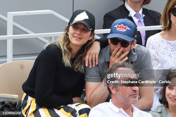 Marion Cotillard and Guillaume Canet attend the 2019 French Tennis Open - Day Fifteenth at Roland Garros on June 09, 2019 in Paris, France.