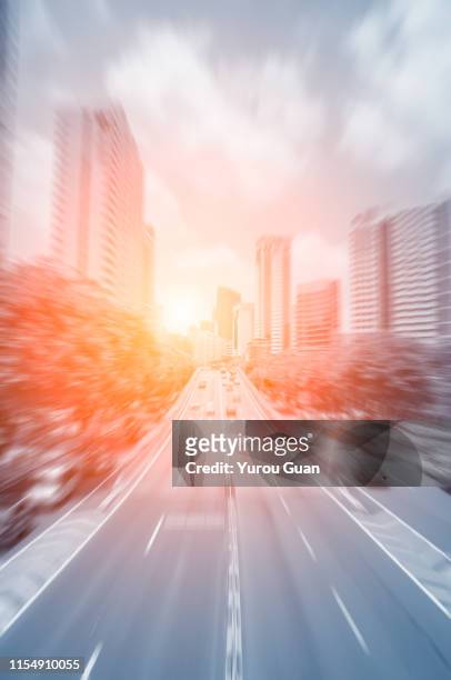 toned image. blurred motion of the city center with the fast car. - fast motion stock pictures, royalty-free photos & images