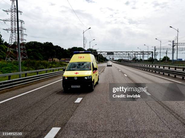 ambulance on highway - ambulance russia stock pictures, royalty-free photos & images