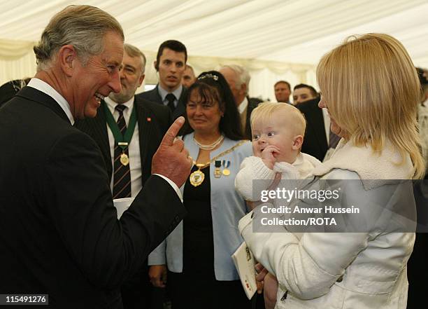 Prince Charles, Prince of Wales jokes with baby Joseph Berry and his mother Jennifer following the dedication ceremony for the new National Armed...