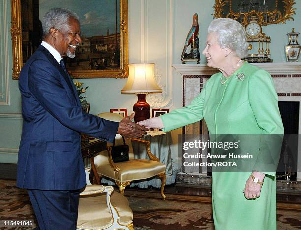 Queen Elizabeth ll invests former Secretary-General of the United Nations, Kofi Annan, with insignia of an Honorary GCMG at Buckingham Palace on...