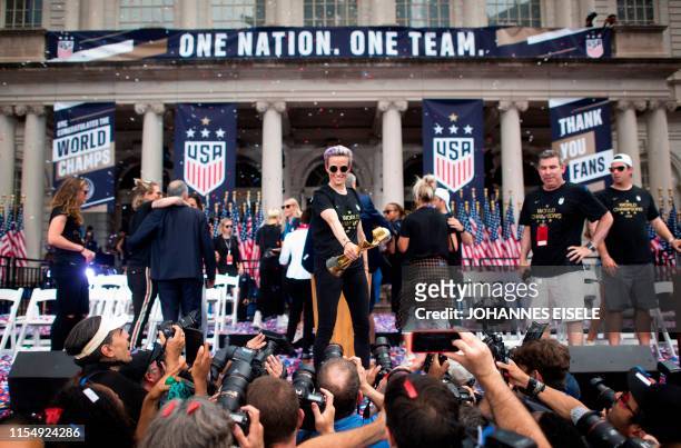 Women's soccer player Megan Rapinoe holds the trophy in front of the City Hall after a ticker tape parade for the women's World Cup champions on July...