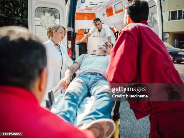 paramedic team pushing stretcher - pushing stretcher stock pictures, royalty-free photos & images