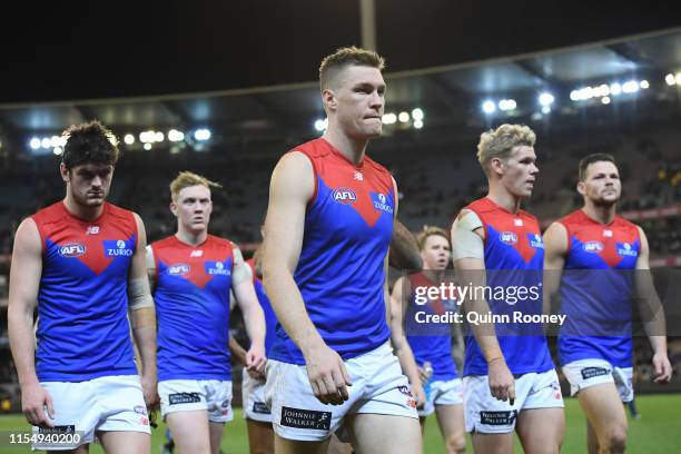 Tom McDonald and his Demons team mates look dejected after losing the round 12 AFL match between the Collingwood Magpies and the Melbourne Demmons at...