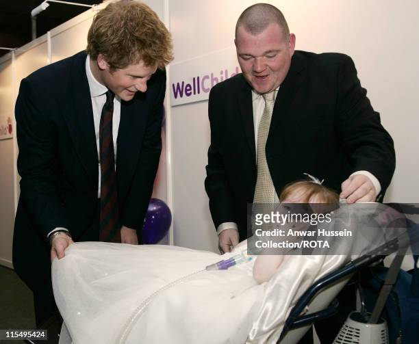 Prince Harry meets 4 year old Katie Ellen Jones, winner of the WellChild Best Brave Child age 4-5 Award, as her father looks on during a ceremony at...