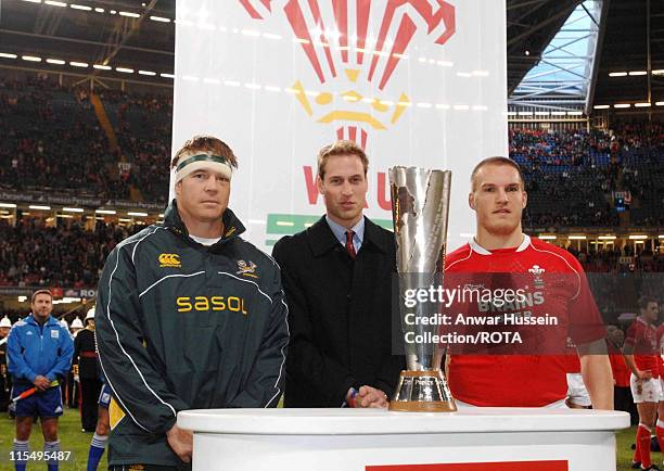 Prince William stands with the Prince William Cup and South Africa's Rugby Team captain John Smith and Wales' captain Gethin Jenkins prior to the...