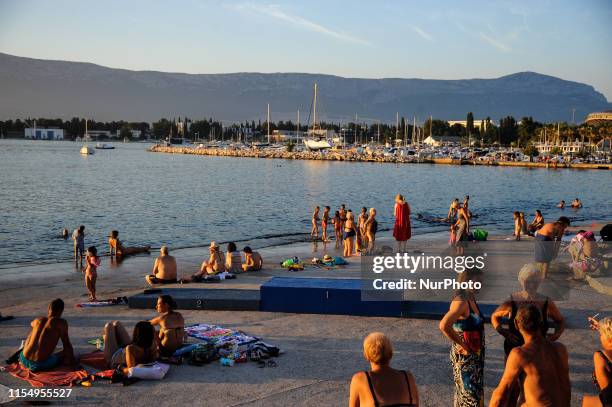 Tourists are seen on one of the beaches of the Croatian city of Split, Croatia on July 10, 2019