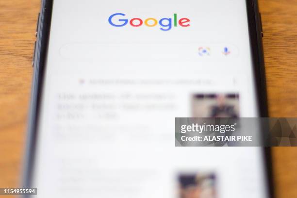 The Google logo is seen on a phone in this photo illustration in Washington, DC, on July 10, 2019.