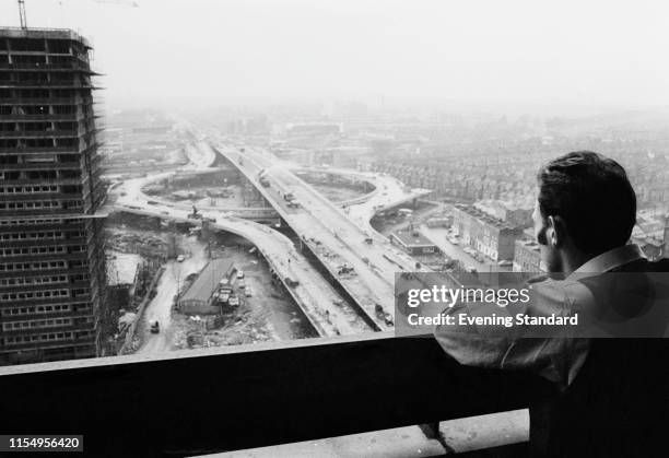 Man looking over the Western Avenue Extension, known as the Westway, under construction, London, UK, 19th January 1970.