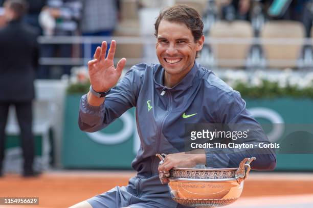 June 09. Rafael Nadal of Spain with the winners trophy on Court Philippe-Chatrier after the Men's Singles Final at the 2019 French Open Tennis...