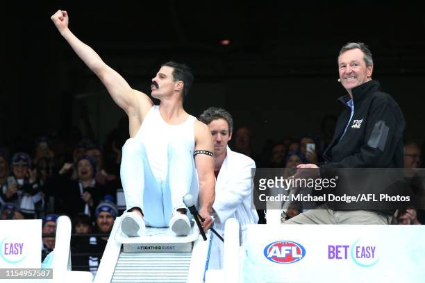 Former St.Kilda player Nick Riewoldt goes down the slide for Big FightMND's Freeze 5 next to Former Essendon player and Melbourne head coach Neale...