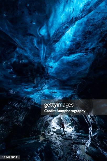 explorer of the ice cave in iceland - inner courage stock pictures, royalty-free photos & images