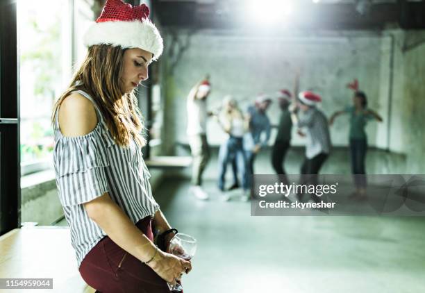 lonely woman feeling sad on a new year's party in the office. - office party stock pictures, royalty-free photos & images