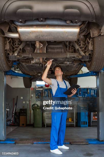 double-checking the steering column - car underside stock pictures, royalty-free photos & images