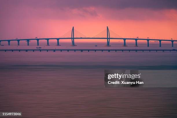hong kong-zhuhai-macau bridge sunset landscape - zhuhai stock pictures, royalty-free photos & images
