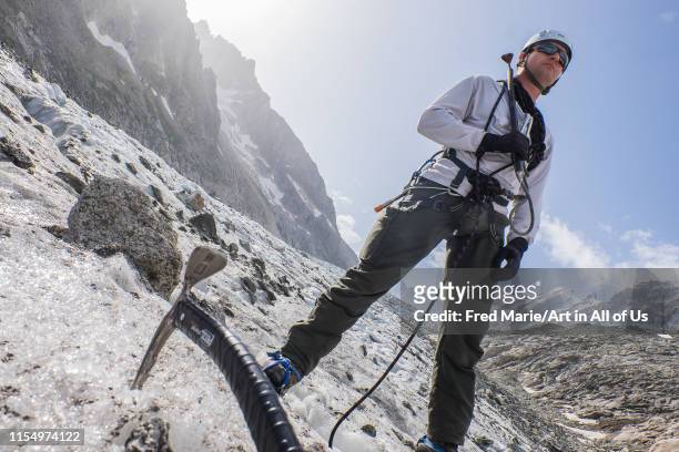 A soldier with ice axs walking during an hiking exercice with the high mountain military school training the future alpine hunters,...