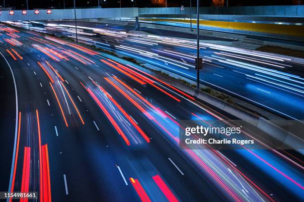 freeway long exposure at night - interstate stock pictures, royalty-free photos & images