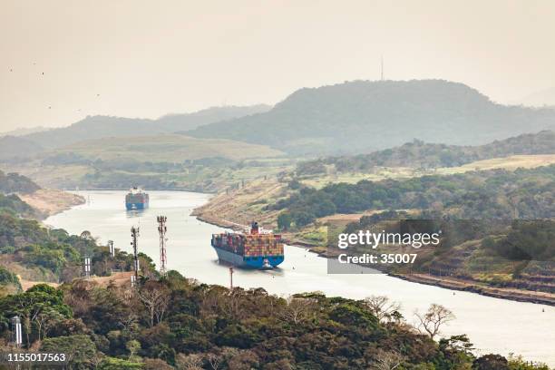 panama canal with huge cargo ships, panama, latin america - panama city stock pictures, royalty-free photos & images