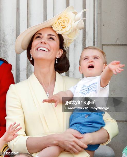 Catherine, Duchess of Cambridge and Prince Louis of Cambridge watch a flypast from the balcony of Buckingham Palace during Trooping The Colour, the...