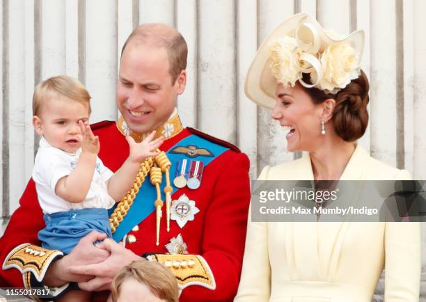 Prince William, Duke of Cambridge, Catherine, Duchess of Cambridge and Prince Louis of Cambridge watch a flypast from the balcony of Buckingham...