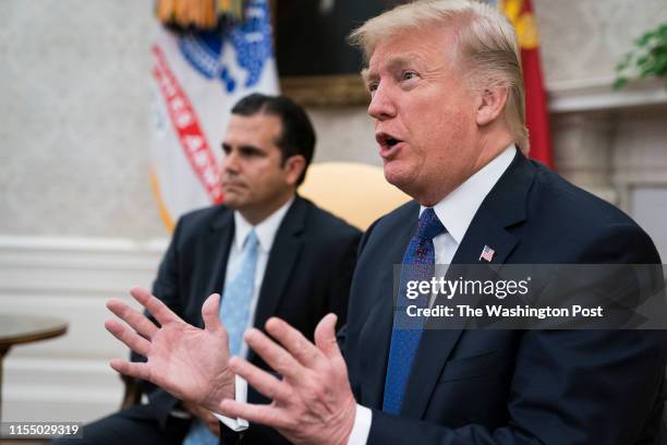 President Donald Trump and Governor Ricardo Rossello of Puerto Rico participate in a meeting in the Oval Office of the White House in Washington, DC...