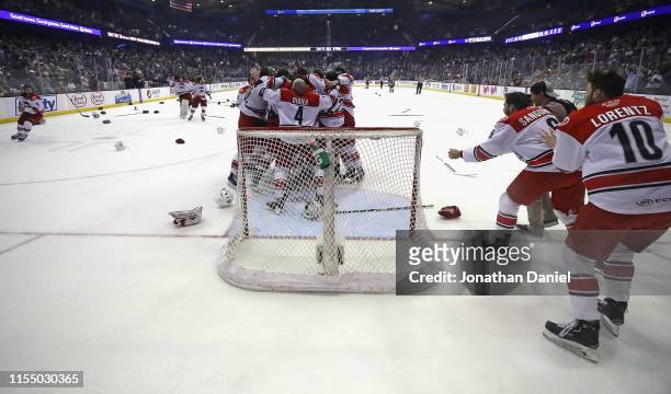 The Charlotte Checkers celebrate a win over the Chicago Wolves during game Five of the Calder Cup Finals at Allstate Arena on June 08, 2019 in...