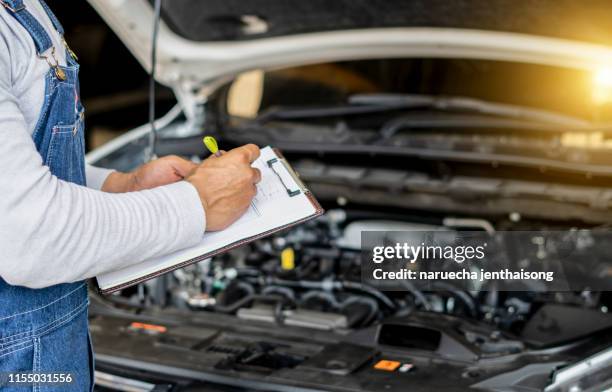 auto mechanic checking car engine. - clipboard stock pictures, royalty-free photos & images