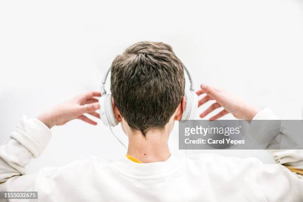 boy listening music with headphones indoor - boy headphones imagens e fotografias de stock