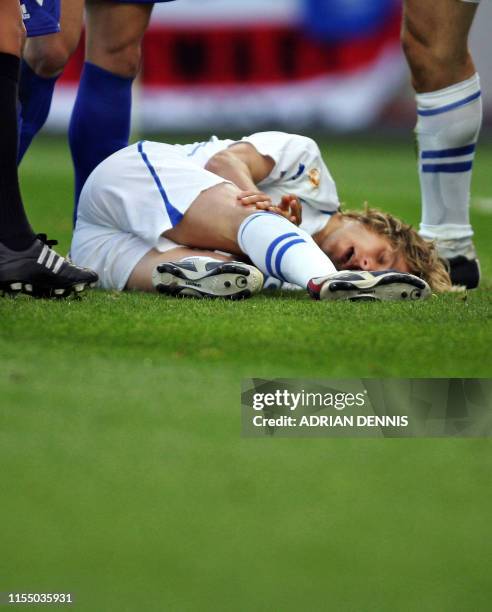 Czech captain Pavel Nedved lies on the ground injured, 01 July 2004 at Dragao stadium in Porto during the Euro 2004 semi-final football match between...