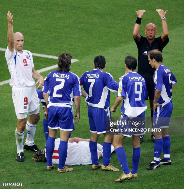 Czech forward Jan Koller and Italian referee Pierluigi Collina ask for medical help as Czech captain Pavel Nedved lies on the ground injured, 01 July...