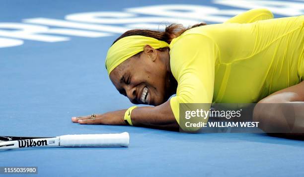 Serena Williams of the US cries out after injuring her ankle during her second round women's singles match against Bojana Jovanovski of Serbia at the...