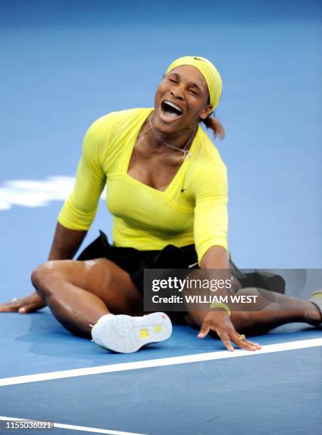 Serena Williams of the US falls to the ground after injuring her ankle during her second round women's singles match against Bojana Jovanovski of...