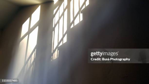 light and shadows of staircase in residential building - schatten im mittelpunkt stock-fotos und bilder