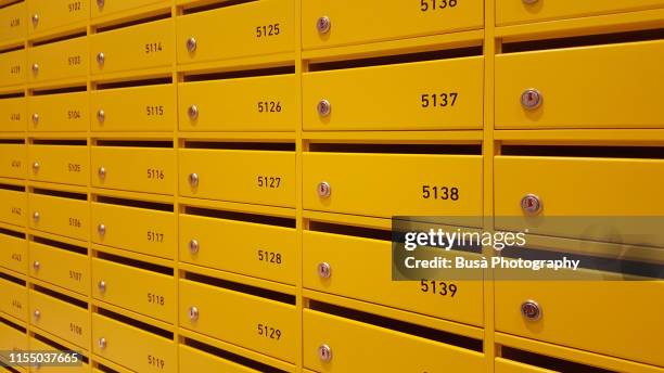 colorful mail boxes inside a hostel in florence, italy - buzones fotografías e imágenes de stock