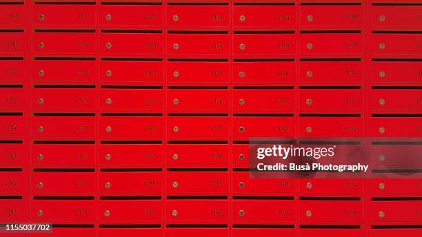 colorful mail boxes inside a hostel (color manipulation) - buzones fotografías e imágenes de stock