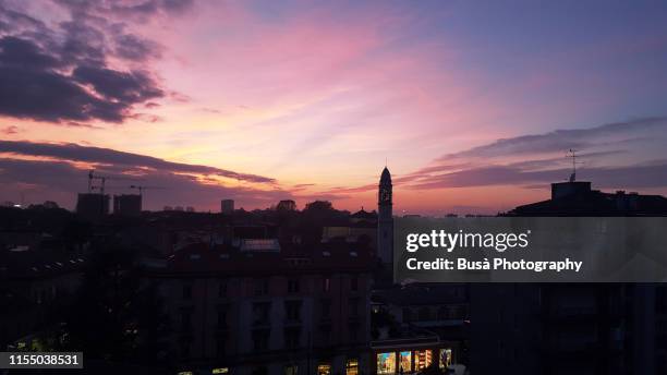 sunset on skyline in milan, italy - skyline milano foto e immagini stock