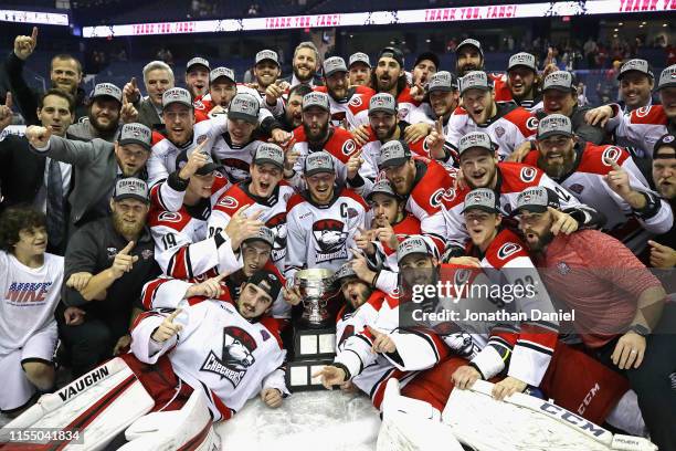 Members of the Charlotte Checkers pose with the Calder Cup following during game Five of the Calder Cup Finals against the Chicago Wolves at Allstate...