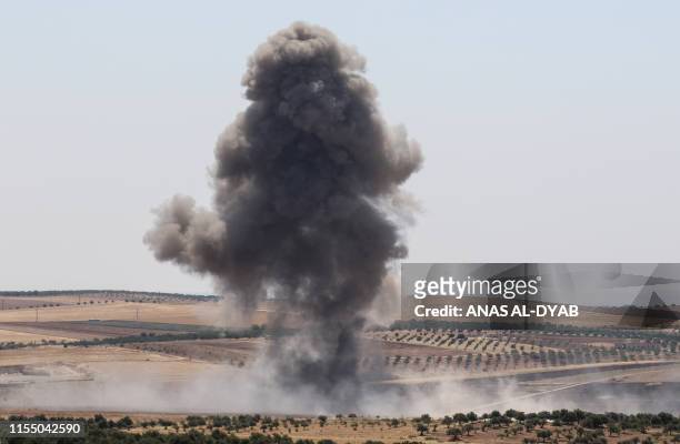 Smoke billows after reported regime air strikes near Khan Sheikhun in Syria's Idlib province on July 11, 2019. - Regime and jihadist-led forces were...
