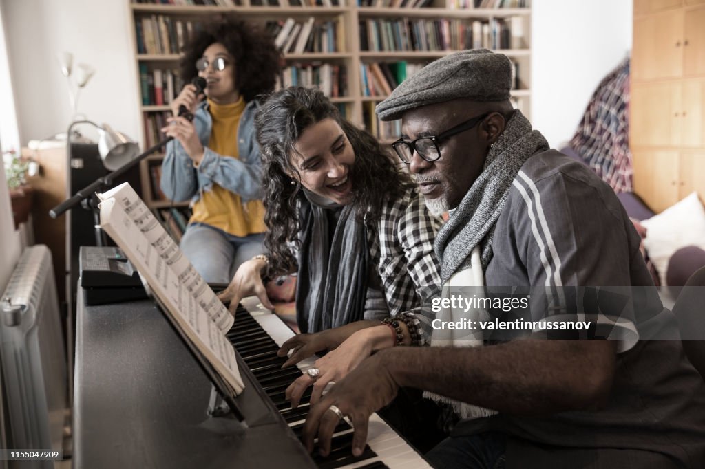 Music Teacher Having Lesson At Piano