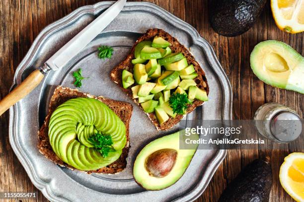 close-up of avocado toast breakfast - avocado slices stock pictures, royalty-free photos & images