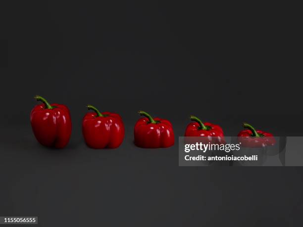 five red peppers in a row - contracting stock pictures, royalty-free photos & images