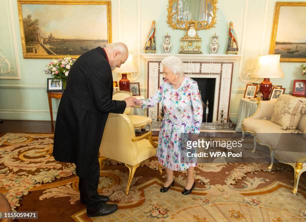 Queen Elizabeth II greets the outgoing Dean of the Chapel Royal Lord Chartres during a private audience at Buckingham Palace on July 11, 2019 in...
