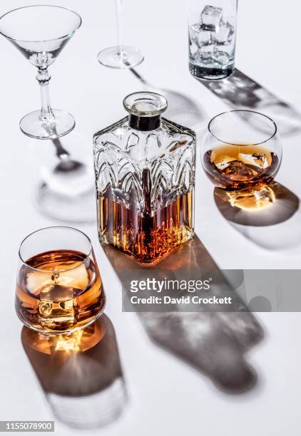 cocktail glasses, whiskey on the rocks and decanter - whiskey stock pictures, royalty-free photos & images