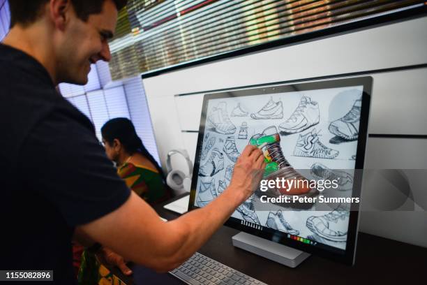 Man colours a shoe on a Microsoft Surface device on July 11, 2019 in London, England. Microsoft opened their first flagship store in Europe this...